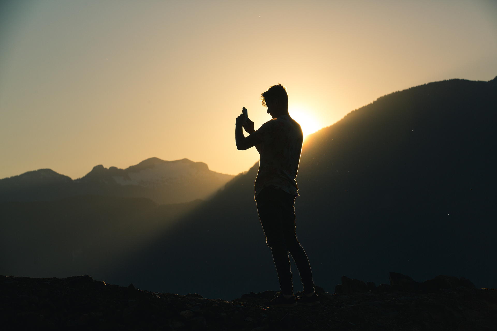SilPerson Taking A Photo On A Mountain
